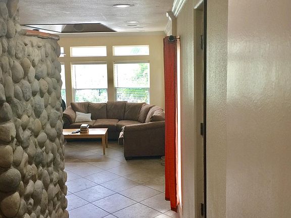 Stepping down into Kitchen area and Living with Rock Wall