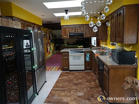 View of kitchen looking towards family room with fireplace