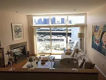 Living room with wood burning fireplace and private deck/bal