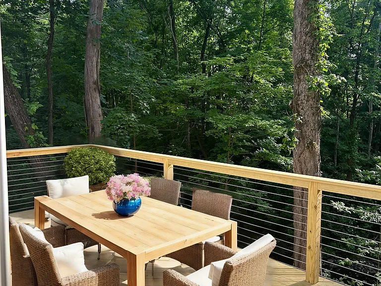 Lower level deck overlooking brook. Virtually Staged