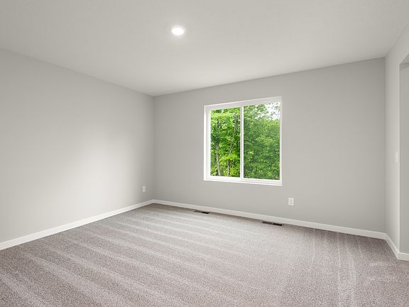 The master bedroom is spacious with a large window.