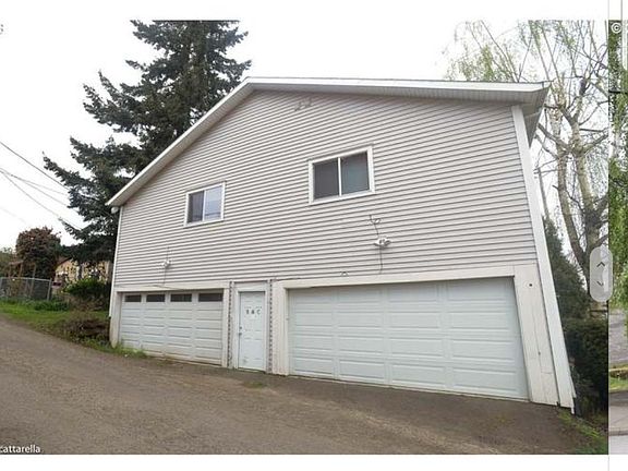 Side of 3 plex and entrance for Unit B & C upstairs. Additional storage in garage that is shared between Unit B & C