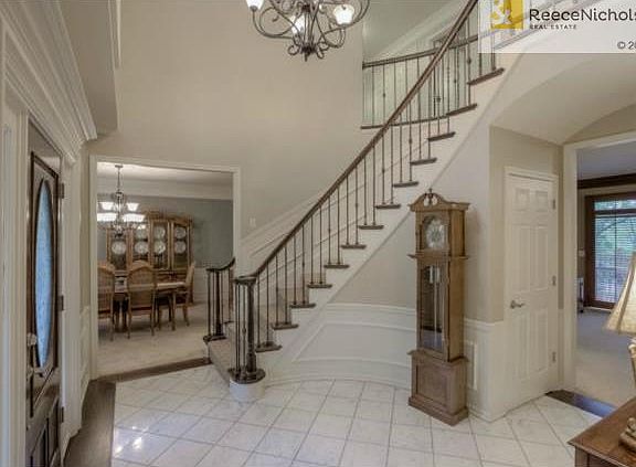 WINDING CURVED STAIRCASE WITH IRON SPINDLES. DINING ROOM IN THE