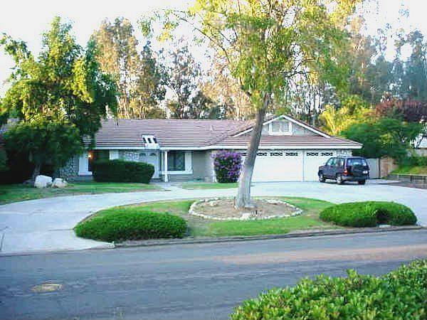 Lovely home on winding, tree-lined street. Wide, circular drive, triple garage