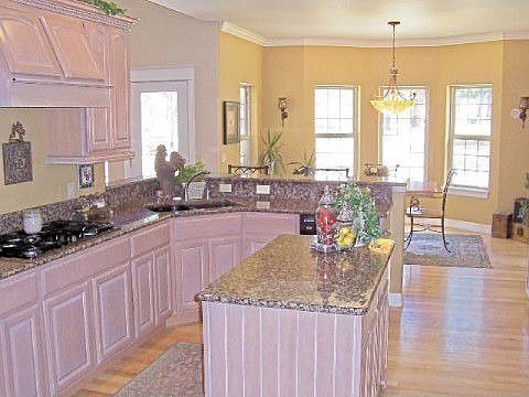 Gourmet kitchen with wood floors and granit