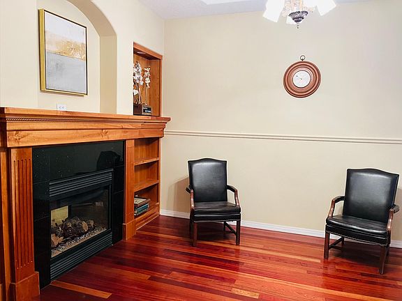Sitting room with double sided gas fireplace and real wood floors