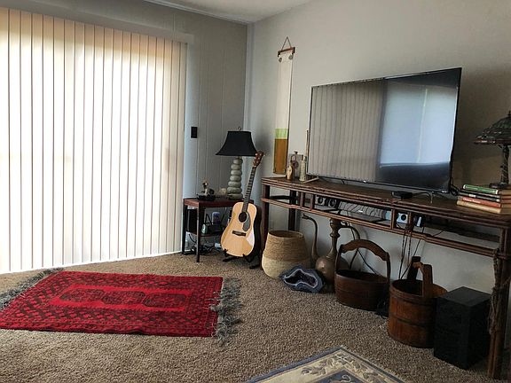 Living Room with sliding glass doors leading to brick patio