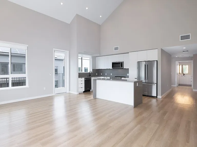 Signature Collection II Apartment kitchen, living, and dining areas with hard-surface vinyl plank flooring