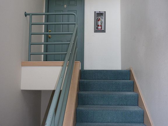 Private inside stairs from the garage with additional storag