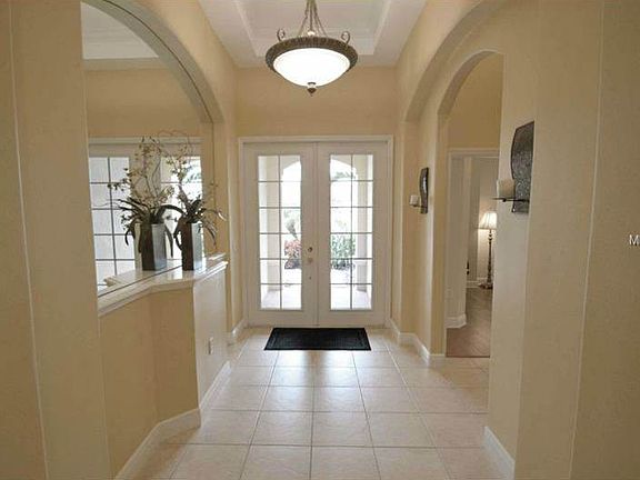 8' tall French doors lead you into a very elegant foyer, featuring step ceilings (11' to 12') and a large mirrored glass niche. The hallway to the right leads to bedrooms 1 & 2 plus a full bathroom.