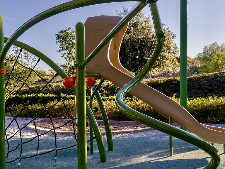 Community Tot Lot: A fully featured, private playground area divided into dedicated sections for both infants and active older toddlers, complete with swings and plenty of space to run.