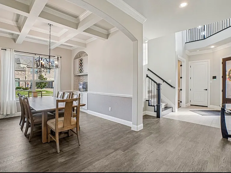 Entry way, stairs to 2nd floor, powder room and dining room