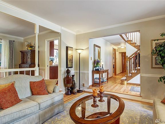 Looking from the living room the kitchen on the left and hallway leading to office, powder room and garage on the right.
