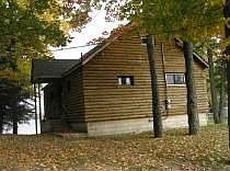 Cottage w 50 ft sandy beach on Manistee Lake. Custom design -remodeling now. 