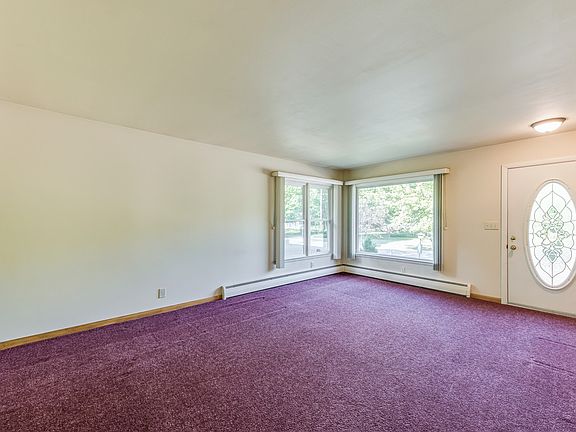 The spacious living room has lots of natural light coming in from it's large windows, a great space to put your personal touches on.
