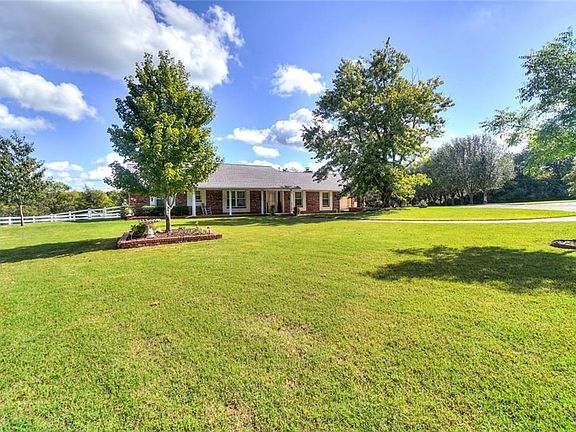 Large front yard with mature trees.