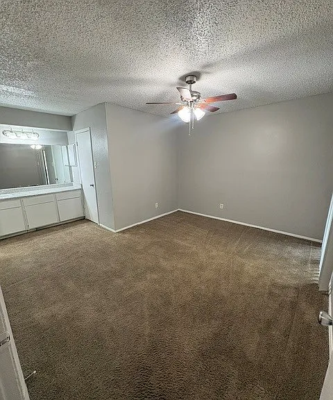 master bedroom with open vanity and 2 walk in closets. master bedroom has access to patio