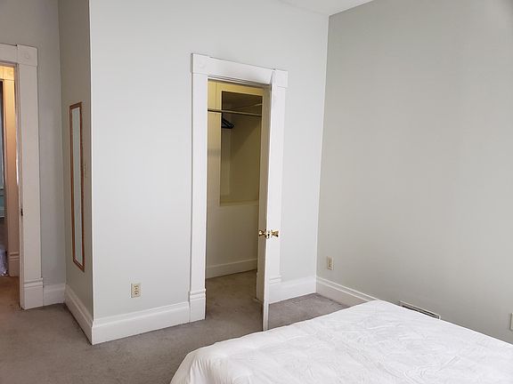 Walk-in closet with extra storage behind.