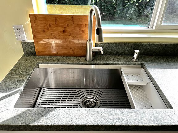 This amazing deep sink features a dish drain and a butcher block that fits on top. Dishes can be done at your leisure and not be seen.