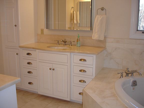 Remodeled master bath with marble counter tops and custom cabinets