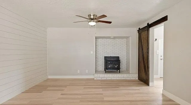 This stove has been removed, and open empty space filled with spacious custom cabinetry.
