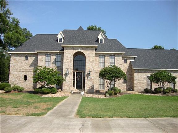  A stunnning home with a full circle driveway and a three car oversized garage.