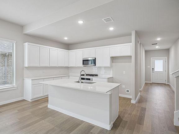 Kitchen in the Stanley II home plan by Trophy Signature Homes - REPRESENTATIVE PHOTO