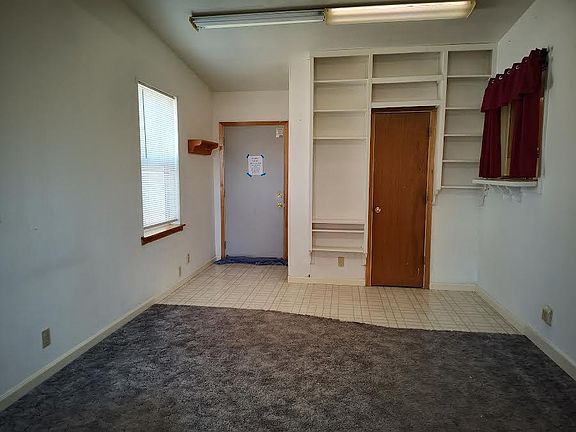 Family room with connected half-bath.