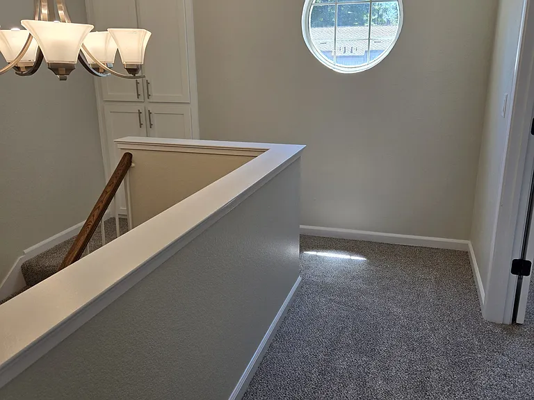 Bright upstairs landing with custom round window.