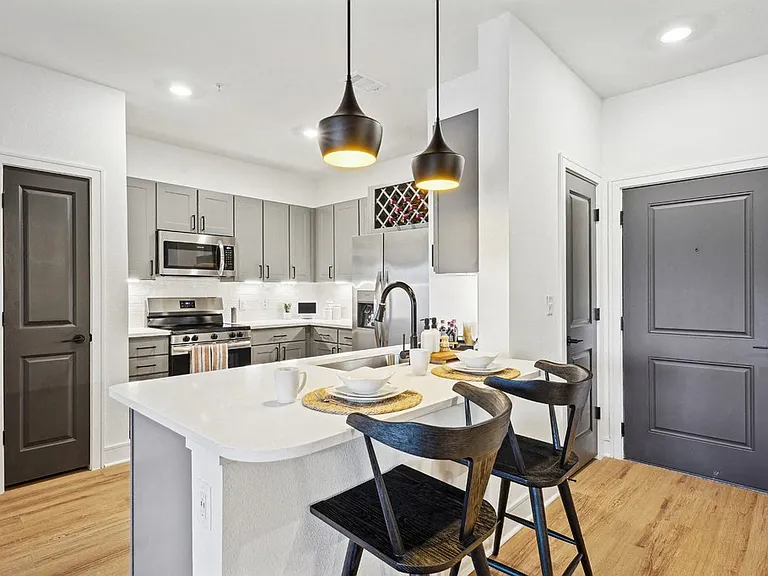 Kitchen with Quartz Countertop and Stainless Steel Appliances.