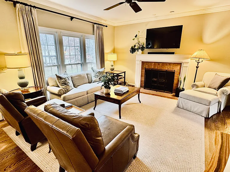 Living room adjacent to formal living room with gas fireplace.