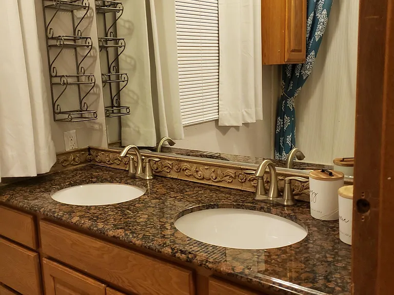Master bath with his and hers sinks in granite top. Spacious drawers. Large, bright window.