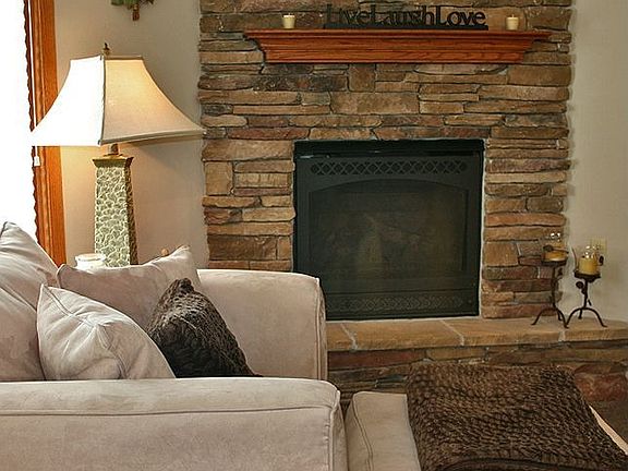 Feel the warmth from the gorgeous stone fireplace in the large living area.