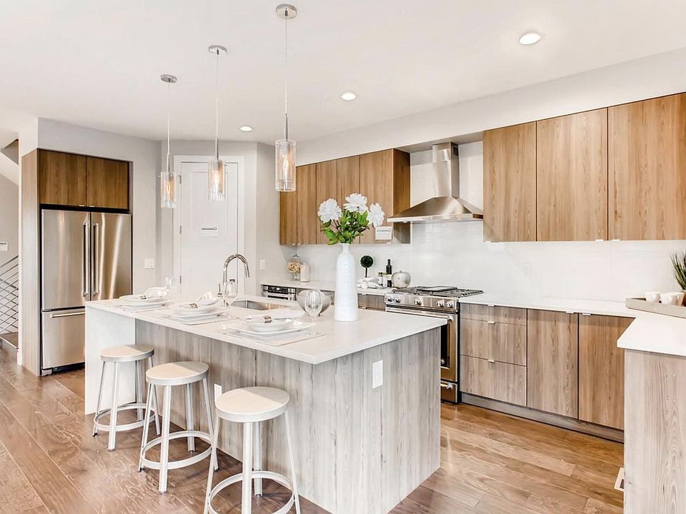 Kitchen has abundant cabinet space and a spacious walk-in pantry to the right of the refrigerator.
