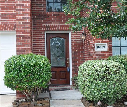 Covered entry with recent mahogany leaded glass front door.