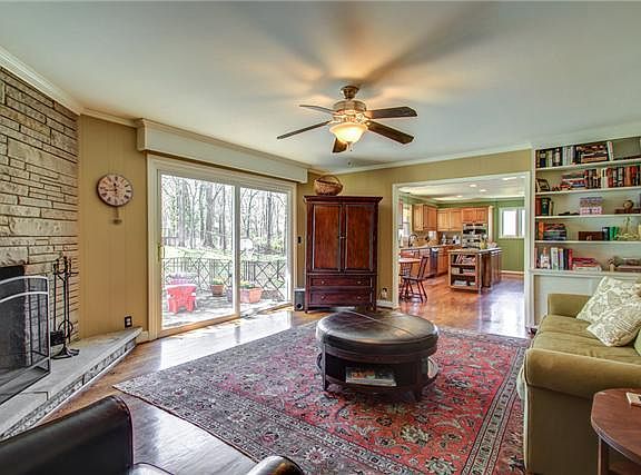 Family room with doors onto porch and fenced back yard