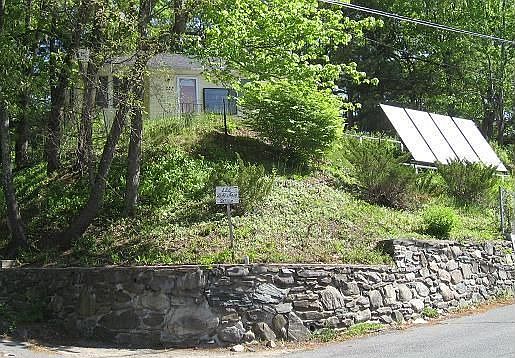 Property from lakeside.  Solar heating panels in front.