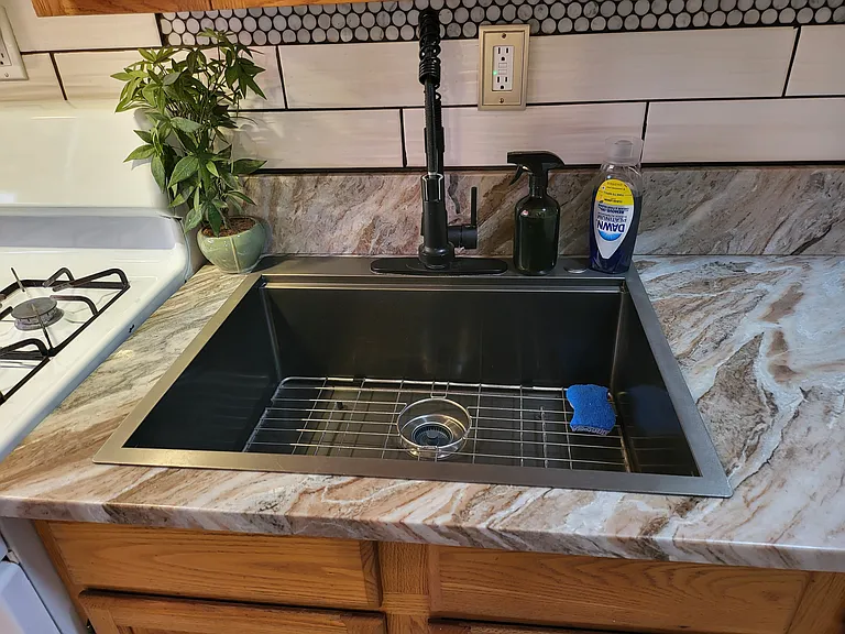 Large (newer) Sink with a Powerful Kitchen Sink Sprayer. Pretty Swirling Marble Counter top.
