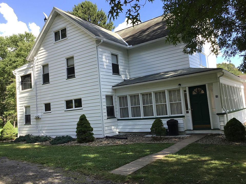 View of House from driveway. There are two apartments, one upstairs and one downstairs. This shows the entrance for the upstairs apartment (Apartment A). Notice the large porch.