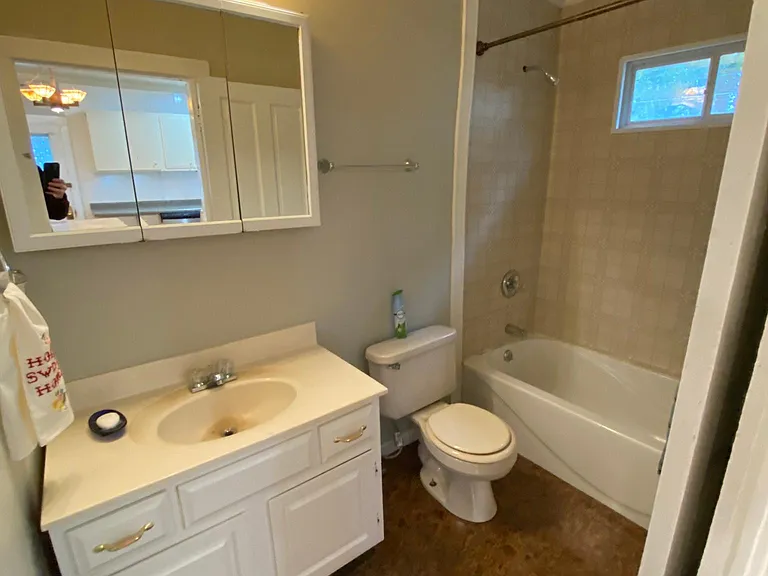 The bathroom off the Third bedroom and kitchen has Craftsman lighting.