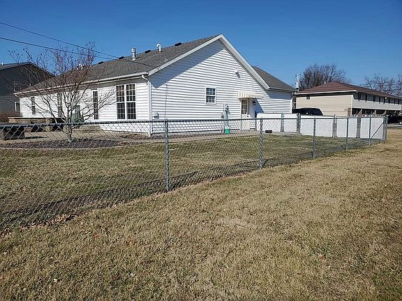 Side view of home with fence