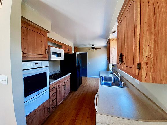 View of kitchen with gas stove. Oven, microwave, stove, dishwasher, sink and countertop all newly installed last summer.