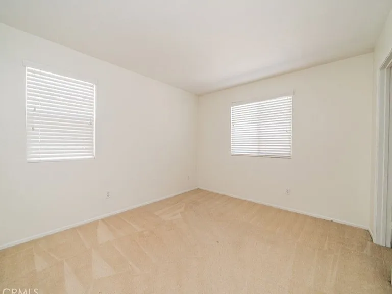 This picture shows one of the bedrooms. All three bedrooms are upstairs. Please note: Home has been upgraded with new carpet that is not shown in this picture.