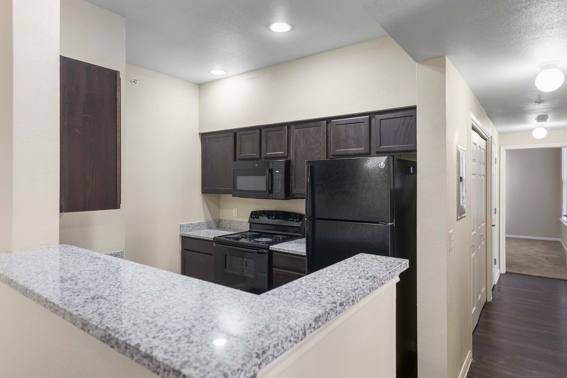 Stylish Kitchen with Granite Countertops and Modern Appliances