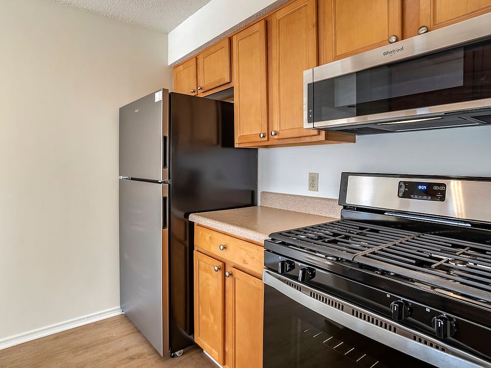 Renovated Package I kitchen with stainless steel appliances, laminate countertops, oak cabinetry, and hard surface flooring