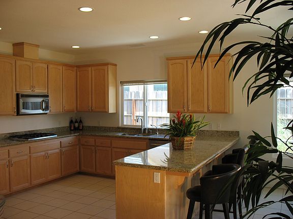 Slab Granite Counter with KitchenAid Stainless Appliances