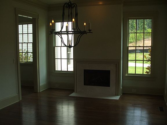 Great room with marble surround fireplace, hardwood floors, 11 ft ceilings