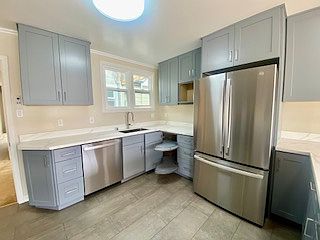 Completely new Kitchen cabinets with soft-close and corner pull out. New Countertops, new Faucet & deep Sink with brand new Stainless-Steel Refrigerator & brand-new Dishwasher