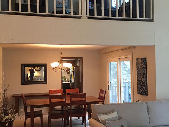 Living room looking into formal dining room with loft above.