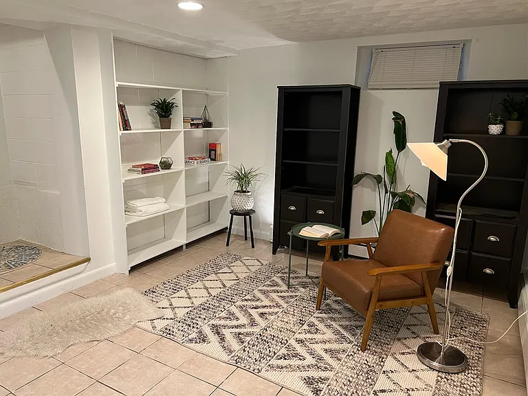 Downstairs bonus room; please note that we have installed new wood flooring throughout this space as well as a door for privacy.